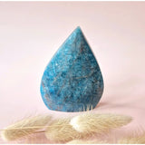 Moonlight Gemstones blue apatite teardrop crystal, standing display with flame-blue hue