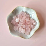 Moonlight Gemstones rose quartz mini star crystals, pink star-shaped stones, 1.5 cm each, in a ceramic bowl.