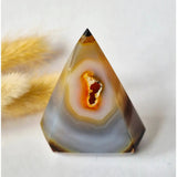 Moonlight Gemstones Druzy gray agate standing crystal pyramid with orange center.