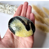 Septarian palmstone by Moonlight Gemstones, yellow calcite crystals in black matrix, worry stone