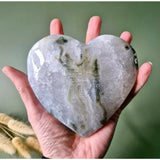 Druzy moss agate heart stone by Moonlight Gemstones held in hand; grey with green veining