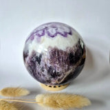 Moonlight Gemstones XL Dream Amethyst gemstone sphere, 100 mm (1255 g), purple and white banded on display stand