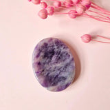 Amethyst worry stone, oval polished purple gemstone for calm and balance; smooth surface with violet marbling.