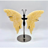 Yellow calcite butterfly crystal sculpture on a metal stand by Moonlight Gemstones