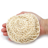 Green-Goose round sisal bath sponge in natural beige held in hand