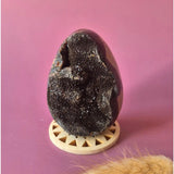 Dragon Stone Septarian Druzy egg on display stand; dark brown with sparkling crystals
