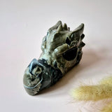 Dragon skull sculpture carved from green volcanic agate, polished, 600 g