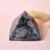 Shungite pyramid, 6 cm, dark stone with reddish veining, for protection and energetic cleansing.