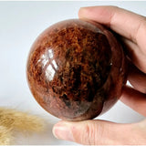 Strawberry Quartz Crystal Sphere by Moonlight Gemstones, polished reddish-brown crystal ball, 60–75 mm