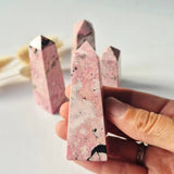Rhodonite towers from Peru, 8–10 cm, pink with black specks — set of 4 polished crystals