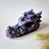 Dragon skull sculpture carved from purple mica with marbled violet and white pattern