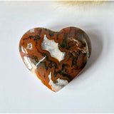 Druzy red moss agate heart, 6–8 cm, orange-brown with white patches and dark veining.