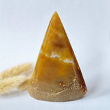 Druzy gray agate standing gemstone crystal pyramid in amber-brown hues