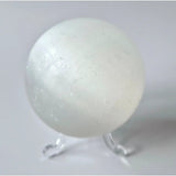 Selenite crystal sphere, 70mm, 436g, milky white on clear display stand