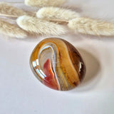 Sardonyx palmstone by Moonlight Gemstones, polished orange-brown banded stone with white lines, 5–10 cm