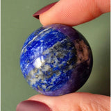 Lapis lazuli gemstone ball, blue with white calcite and gold pyrite specks, 4–5 cm.