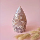 Druzy pink amethyst freeform teardrop crystal with white matrix on soft pink backdrop