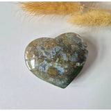 Heart-shaped druzy moss agate pendant stone, earth-tone greens and browns with blue accents, 6–8 cm