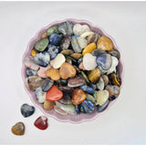 Mini Heart pocketstones by Moonlight Gemstones, heart-shaped crystals in a pink scalloped bowl of mixed colors