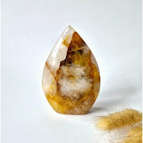 Moonlight Gemstones Golden Healer teardrop quartz crystal, standing upright with golden-brown bands