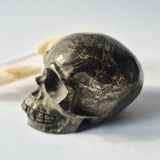 Pyriet Skull by Moonlight Gemstones, hand-carved crystal skull in dark pyrite with gold veining, 690 g