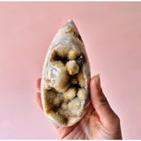 Druzy rose-amethyst freeform crystal cluster in a smooth teardrop geode shell