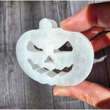 Selenite pumpkin carving ornament by Moonlight Gemstones; white translucent jack-o'-lantern cutout