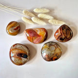 Sardonyx palmstones set of 5, polished orange-brown banded stones.