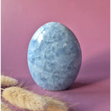 Celestite freeform gemstone in soft blue with a faceted, polished oval shape