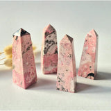 Moonlight Gemstones Rhodonite towers from Peru, pink with black veining, set of 4, 8–10 cm each.