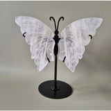 Rose quartz butterfly crystal carving on a black metal stand