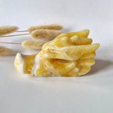 Honey calcite dragon skull sculpture by Moonlight Gemstones, yellow hue, 10 cm.