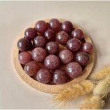 Strawberry quartz crystal spheres, 20–30mm, polished pink orbs in a wooden bowl