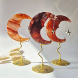 Three fire quartz crescent moons on gold-tone stands with dangling star charms, Moonlight Gemstones.