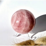 Rose quartz sphere, 60mm pink crystal on clear display stand