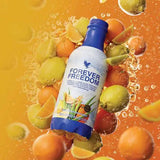 Forever Freedom collagen drink bottle by Joily's, blue cap, surrounded by oranges and limes.