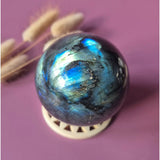 Labradorite sphere by Moonlight Gemstones, iridescent blue-green flash, polished 50–85mm orb on display ring