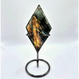 Labradorite gemstone on diamond-shaped display stand with metal prongs, Moonlight Gemstones