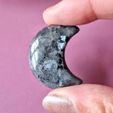 Larvikite crescent handstone, gray with black specks, polished palmstone 3 cm