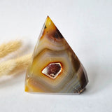 Druzy grey agate standing pyramid gemstone from Moonlight Gemstones with amber bands and brown center cavity