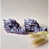 Pair of purple mica dragon skulls gemstone sculptures with lilac and white marbling