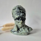 Emerald-in-Matrix Native American bust carving by Moonlight Gemstones, green with black matrix, about 10 cm.