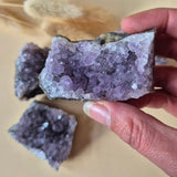 Amethyst crystal clusters on rock matrix; purple crystals, set of three