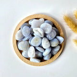 Moonlight Gemstones blue lace agate palm stones, 3 cm, pale blue-gray pebbles in a wooden bowl