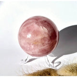 Moonlight Gemstones rose quartz crystal sphere, 60mm pink polished ball on a display stand