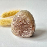 Druzy agate geode egg with pink crystals and pale cream exterior