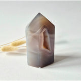 Druzy agate tower geode in purple-gray hues with an interior druzy crystal cavity.
