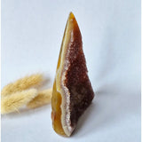 Druzy gray agate standing crystal geode with yellow outer band and brown druzy interior.