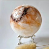 XL fire quartz crystal ball, 88 mm (935 g), orange-brown with white inclusions on a decorative metal stand