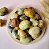 Crazy Mexican Agate hand stones from Moonlight Gemstones, polished palm stones with colorful banding (5–7 cm) in a bowl